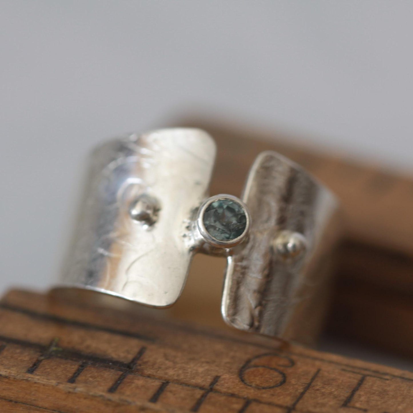 Montana Glacial Blue Sapphire on Wide Sterling Silver Band with Intricate Roll Print Design